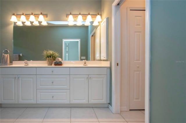 full bathroom with a sink, double vanity, and tile patterned floors