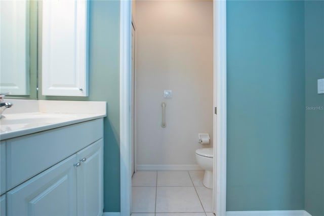 bathroom featuring tile patterned flooring, toilet, vanity, and baseboards