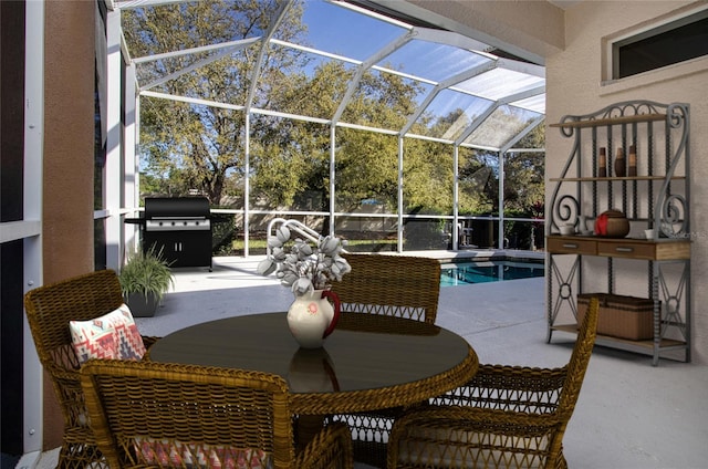 view of patio / terrace with grilling area, glass enclosure, and an outdoor pool