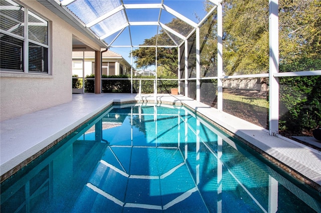 outdoor pool featuring a lanai and a patio area