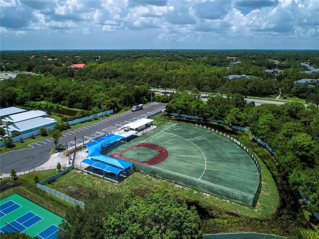 birds eye view of property featuring a view of trees