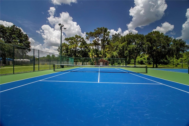 view of tennis court with fence