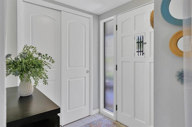 foyer entrance with light tile patterned floors