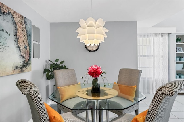 tiled dining area with an inviting chandelier