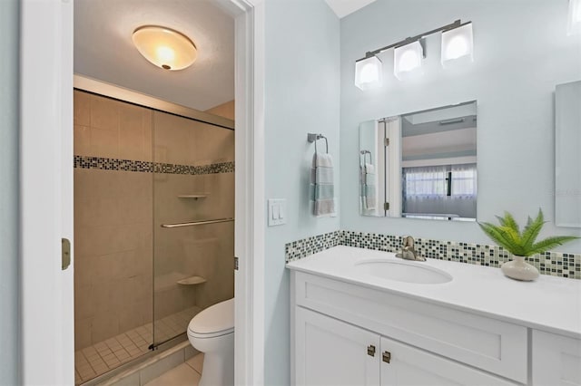 full bathroom featuring decorative backsplash, toilet, and a stall shower