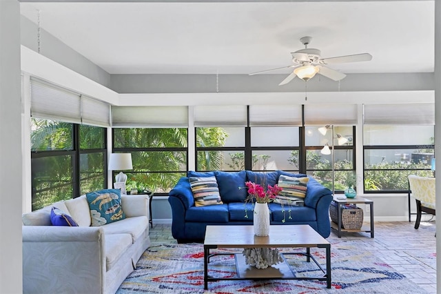 sunroom / solarium with a healthy amount of sunlight and a ceiling fan