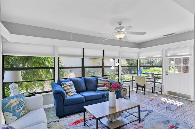 sunroom with visible vents and ceiling fan