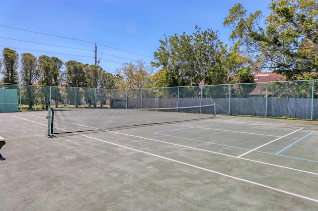 view of tennis court with fence