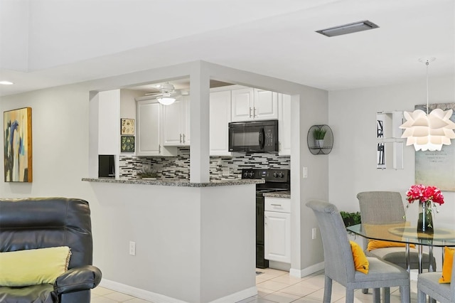 kitchen with visible vents, black appliances, tasteful backsplash, dark stone counters, and white cabinets