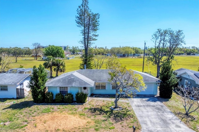 ranch-style house with driveway and a front yard