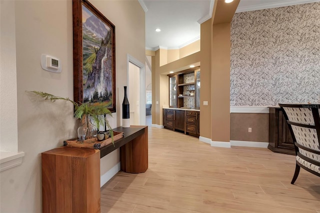 corridor featuring recessed lighting, baseboards, light wood finished floors, and ornamental molding