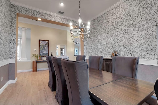 dining area featuring a notable chandelier, visible vents, wood finished floors, and ornamental molding