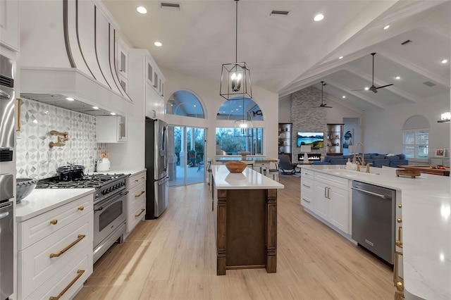 kitchen with a spacious island, visible vents, open floor plan, stainless steel appliances, and a sink