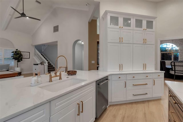 kitchen with a ceiling fan, a sink, white cabinets, light wood-style floors, and dishwasher