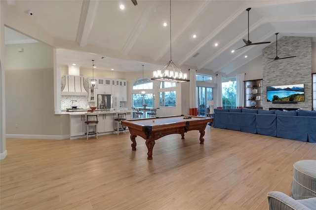 game room with ceiling fan, beam ceiling, light wood finished floors, and high vaulted ceiling