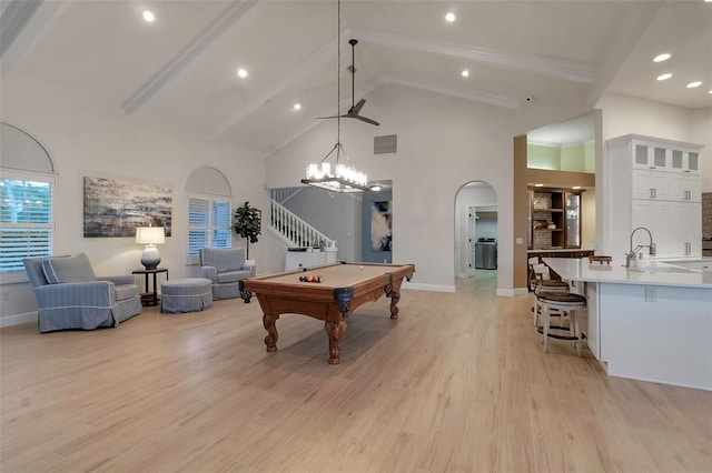 recreation room featuring light wood finished floors, visible vents, beamed ceiling, and high vaulted ceiling