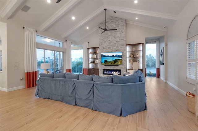 living area with baseboards, light wood finished floors, high vaulted ceiling, a stone fireplace, and beamed ceiling