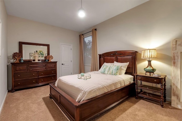 bedroom with baseboards and light carpet