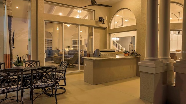 reception area featuring decorative columns and stairs