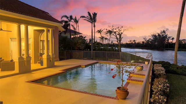 view of swimming pool with a fenced in pool and a water view