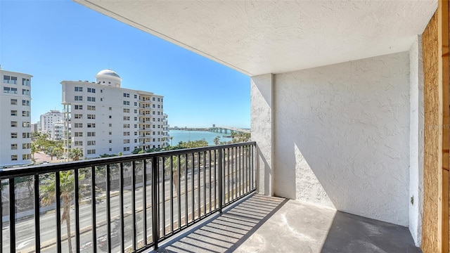 balcony with a view of city and a water view