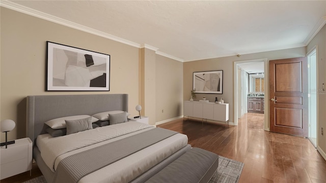 bedroom with baseboards, wood-type flooring, and ornamental molding