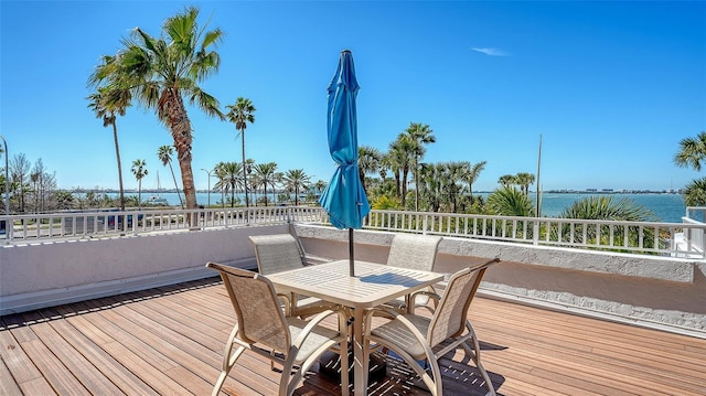 wooden deck featuring outdoor dining area and a water view