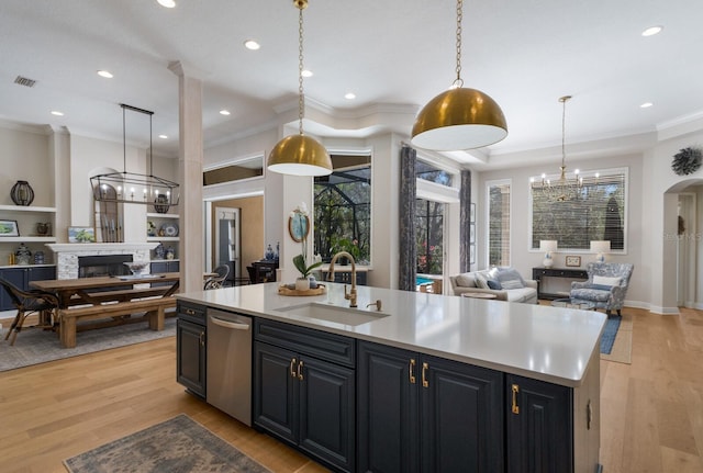 kitchen with visible vents, open floor plan, dishwasher, a fireplace, and a sink