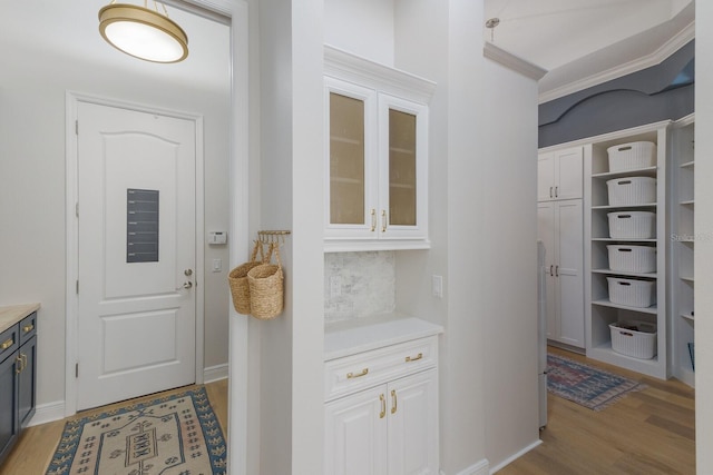 hall featuring baseboards and light wood finished floors