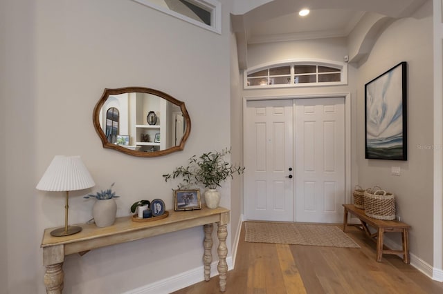 foyer entrance featuring recessed lighting, baseboards, wood finished floors, and ornamental molding