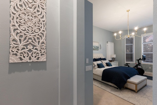 bedroom with a notable chandelier and carpet floors