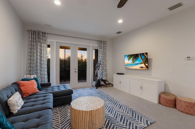 living area with recessed lighting, french doors, visible vents, and light carpet