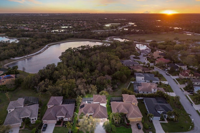 drone / aerial view featuring a residential view and a water view