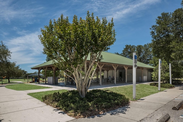 surrounding community featuring a gazebo, a lawn, and an attached garage