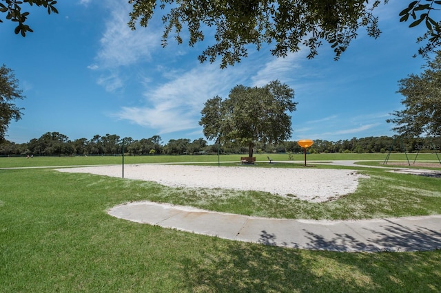 view of community featuring a lawn and volleyball court