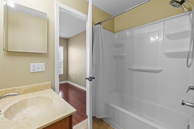 bathroom with vanity, baseboards, and shower / tub combo with curtain