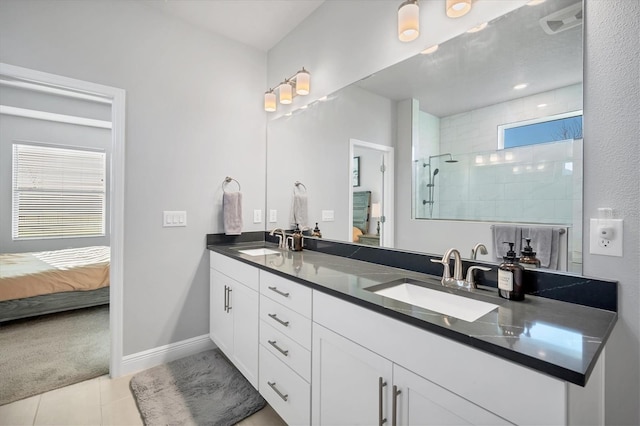 full bath with a sink, a walk in shower, tile patterned flooring, and connected bathroom