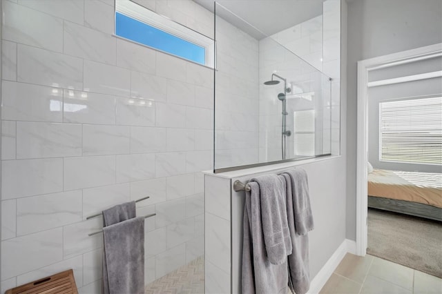 ensuite bathroom with tile patterned floors, baseboards, ensuite bathroom, and walk in shower