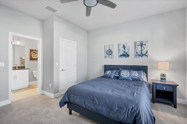 bedroom with baseboards, visible vents, and light carpet