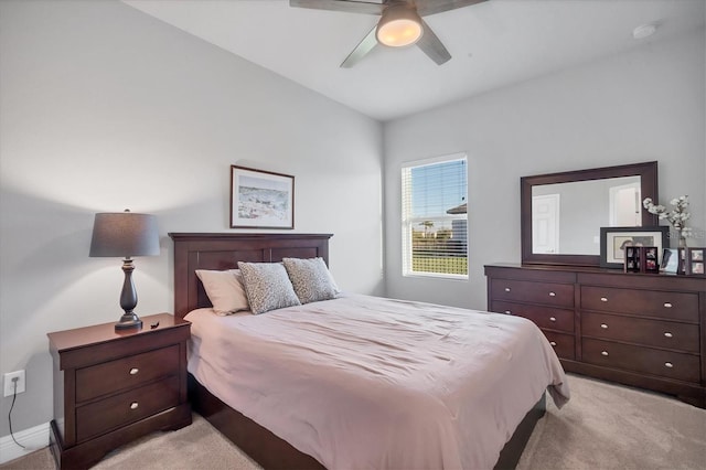 bedroom featuring light colored carpet and a ceiling fan