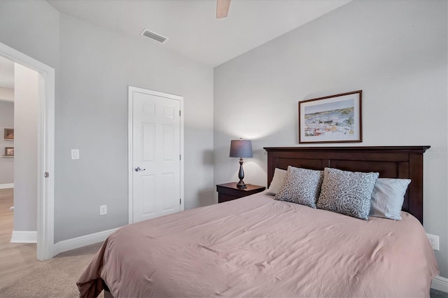 bedroom featuring light colored carpet, baseboards, visible vents, and ceiling fan