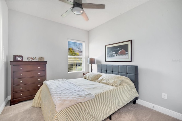 bedroom featuring baseboards, light carpet, and ceiling fan