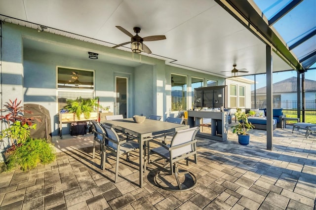 view of patio with outdoor dining space, a lanai, outdoor lounge area, and ceiling fan