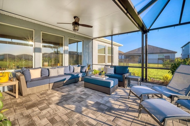 sunroom / solarium with a wealth of natural light and a ceiling fan