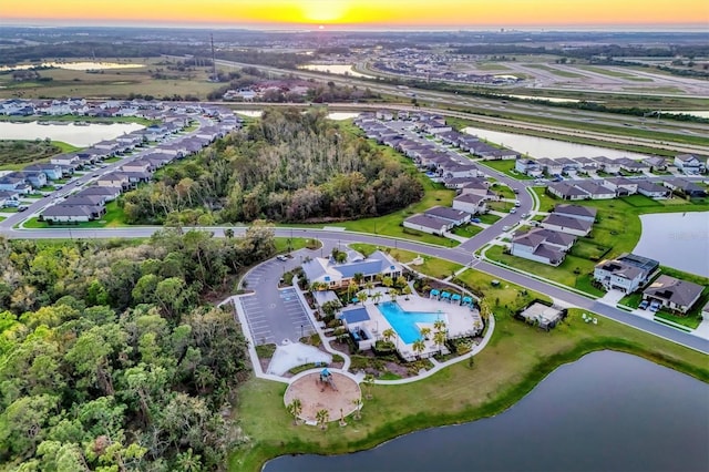 birds eye view of property with a residential view and a water view