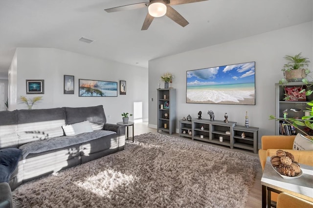 living area featuring visible vents and a ceiling fan