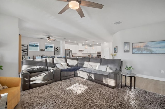 living room with visible vents, baseboards, ceiling fan, and wood finished floors