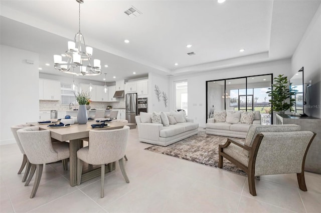 dining space with recessed lighting, visible vents, and a raised ceiling