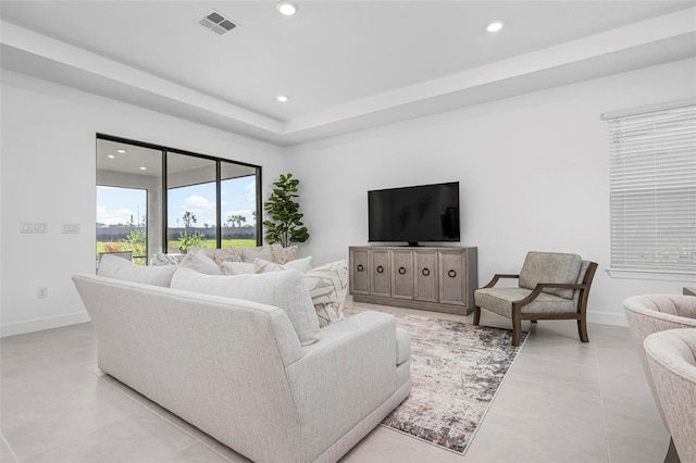 living room with recessed lighting, visible vents, and baseboards