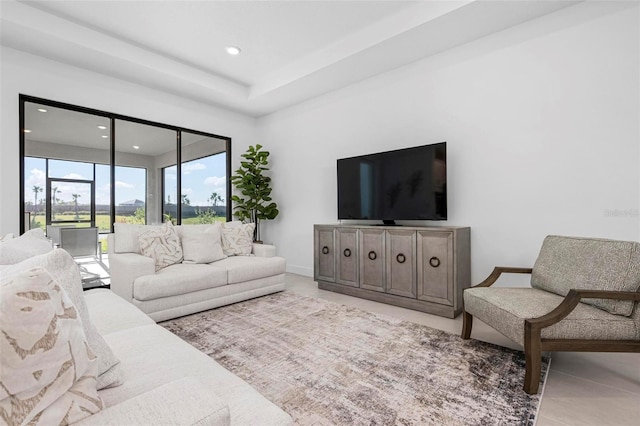 living room with tile patterned floors, recessed lighting, and baseboards